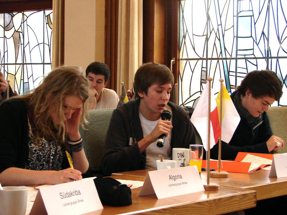 Young people assume the role of delegates of the United Nations.  